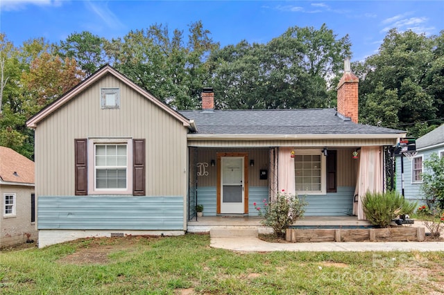 515 Suttle St, Shelby, NC 28150 - bungalow-style home with covered porch, roof with shingles, a front lawn, and a chimney