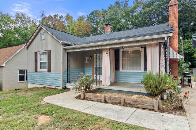 515 Suttle St, Shelby, NC 28150 - view of front of house with a chimney, a shingled roof, and covered porch