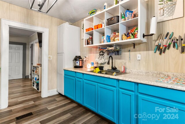 515 Suttle St, Shelby, NC 28150 - kitchen with a sink, blue cabinets, visible vents, light countertops, and dark wood-style floors