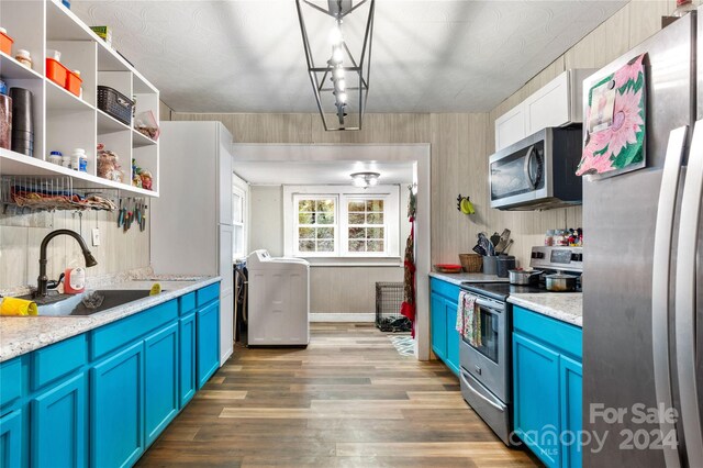 515 Suttle St, Shelby, NC 28150 - kitchen with a sink, wood finished floors, blue cabinets, light countertops, and appliances with stainless steel finishes
