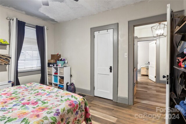 515 Suttle St, Shelby, NC 28150 - bedroom featuring baseboards, ceiling fan with notable chandelier, and wood finished floors