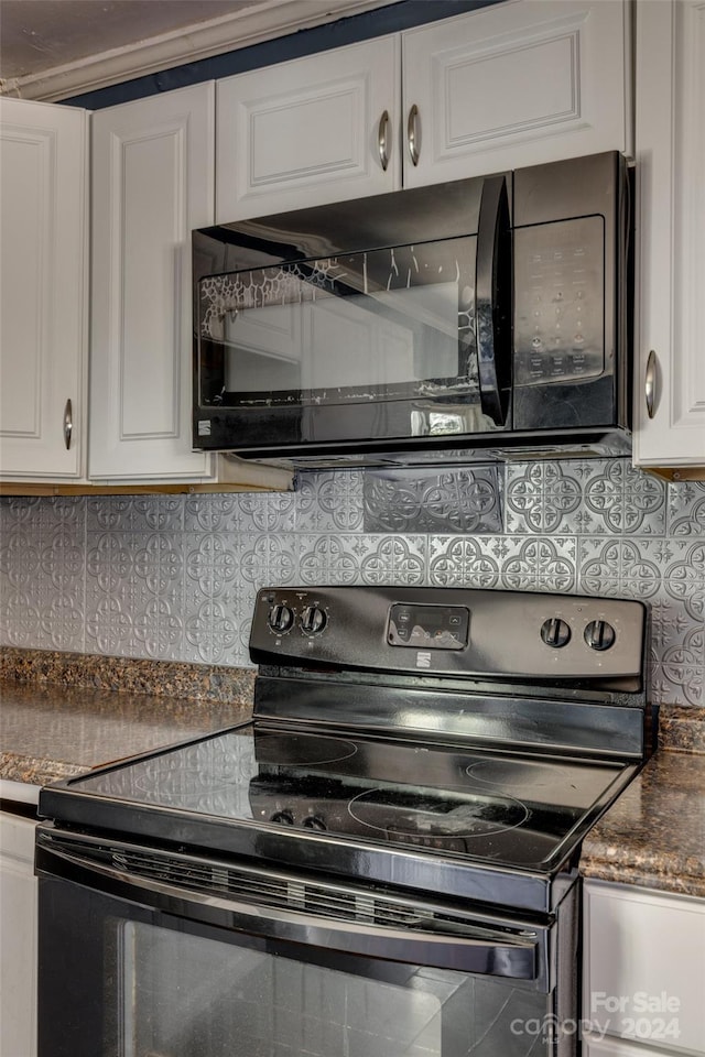 kitchen featuring decorative backsplash, white cabinetry, and black appliances