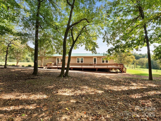 rear view of house with a deck and metal roof