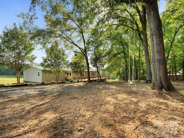 view of yard with a wooden deck