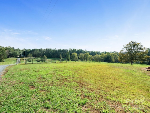 view of yard featuring a rural view and fence