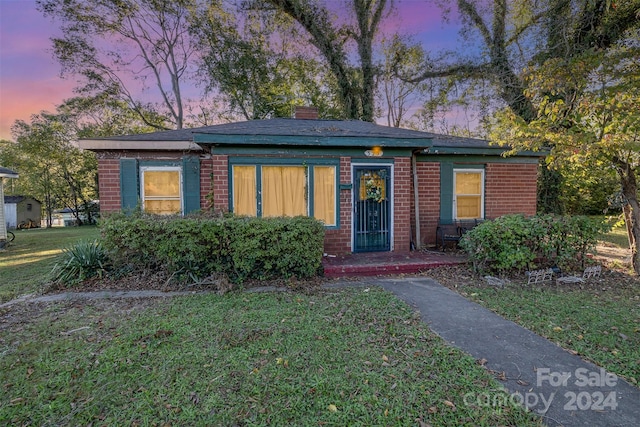 view of front of house with a yard