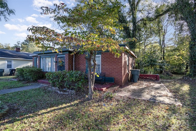 view of side of home featuring a lawn