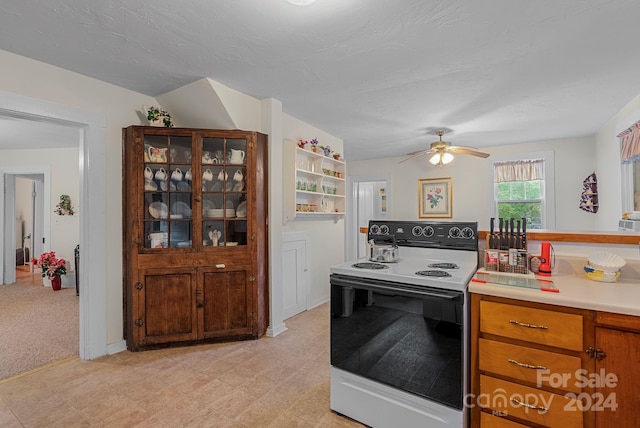 kitchen with white electric range oven, a textured ceiling, and ceiling fan