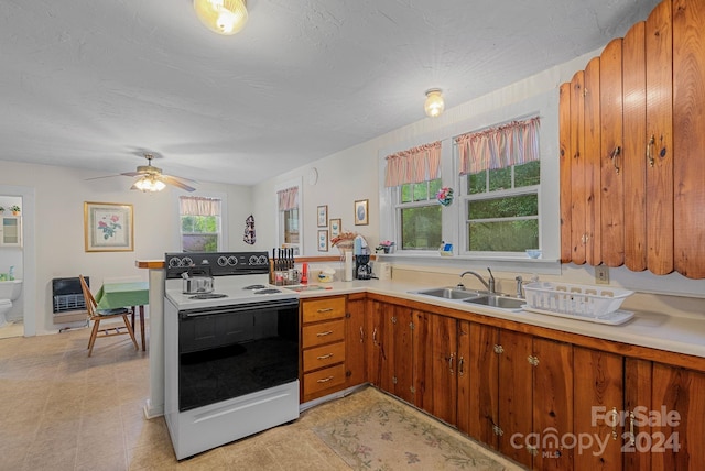 kitchen featuring ceiling fan, a textured ceiling, white electric range oven, and sink