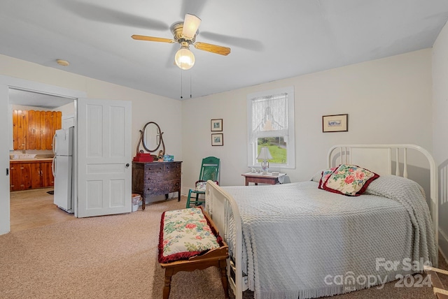 carpeted bedroom with ceiling fan and white refrigerator