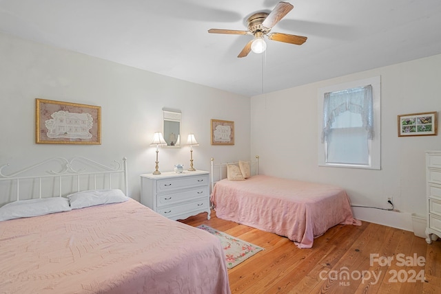 bedroom with ceiling fan and light hardwood / wood-style flooring