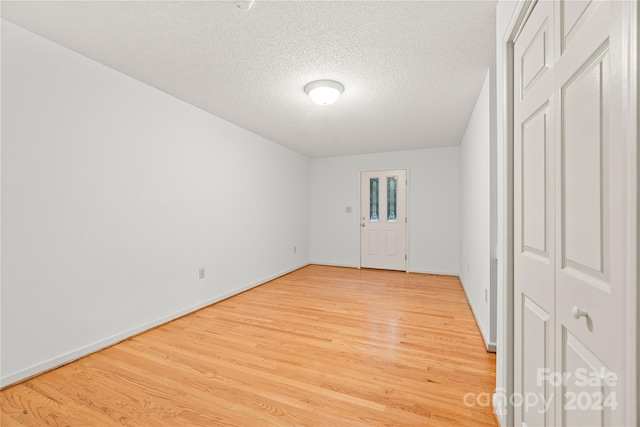 empty room featuring hardwood / wood-style floors and a textured ceiling