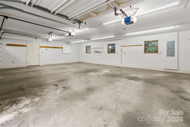 garage with a garage door opener and electric panel