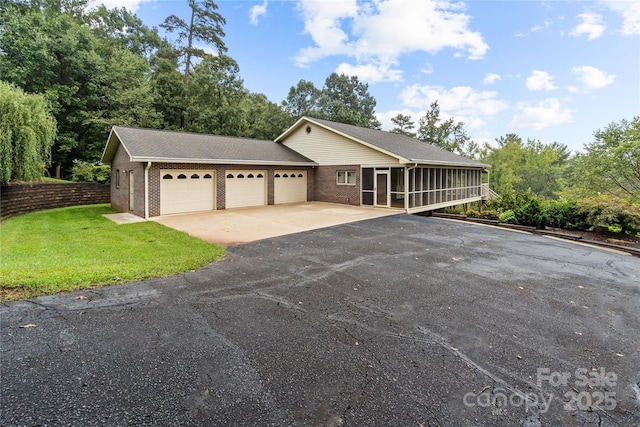 2066 Waterford Way, Morganton, NC 28655 - ranch-style house with aphalt driveway, a sunroom, a garage, and brick siding