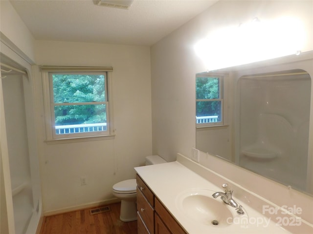 2066 Waterford Way, Morganton, NC 28655 - bathroom with walk in shower, toilet, wood finished floors, vanity, and visible vents