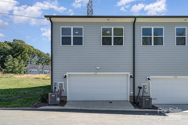 exterior space featuring a garage and central AC