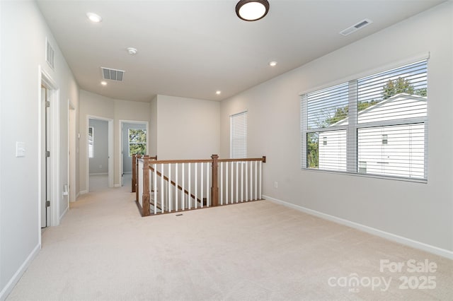 empty room featuring light colored carpet