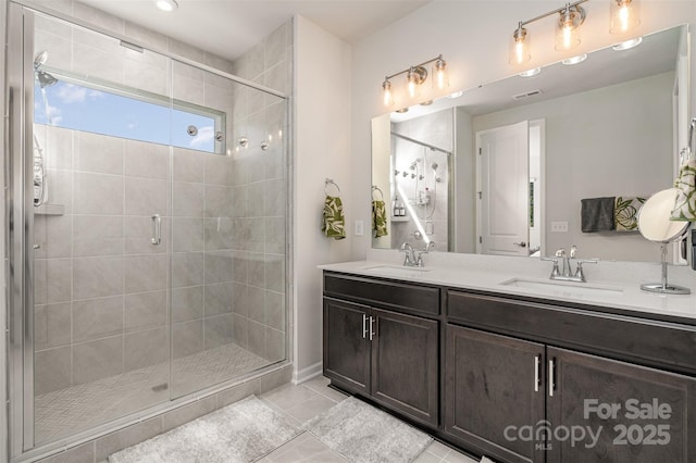 bathroom featuring vanity, an enclosed shower, and tile patterned flooring