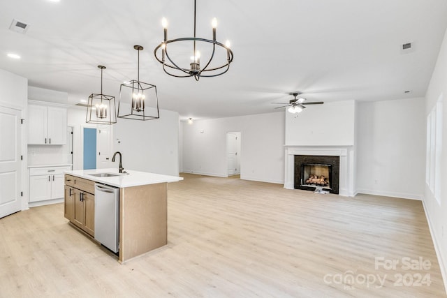 kitchen featuring sink, hanging light fixtures, white cabinetry, a center island with sink, and dishwasher