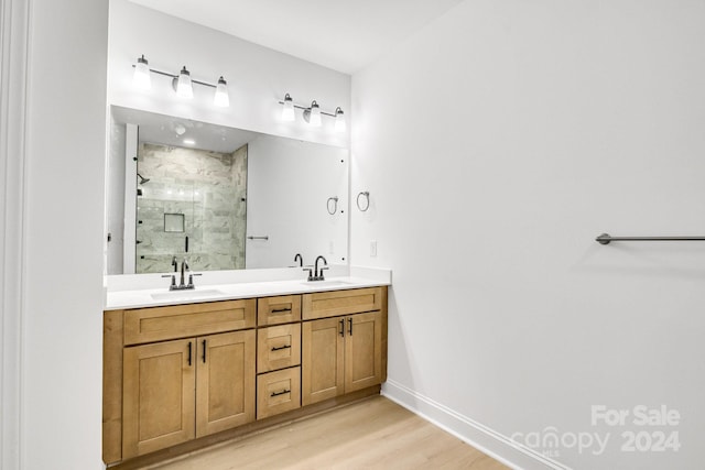 bathroom with walk in shower, hardwood / wood-style floors, and vanity