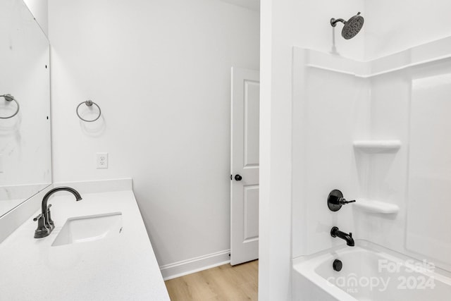 bathroom featuring vanity, hardwood / wood-style flooring, and bathtub / shower combination