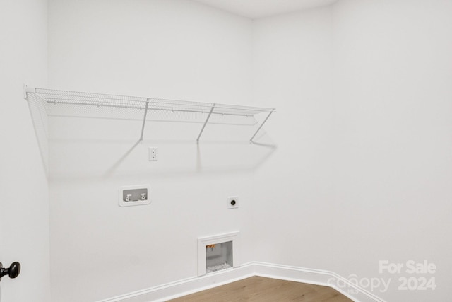 clothes washing area featuring washer hookup, hardwood / wood-style floors, and electric dryer hookup