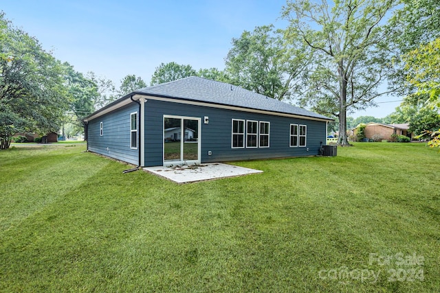 back of property with cooling unit, a patio, and a lawn