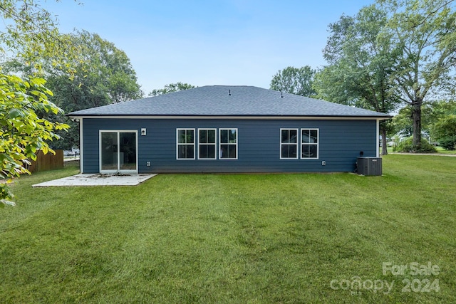 back of property featuring a patio, a lawn, and central AC