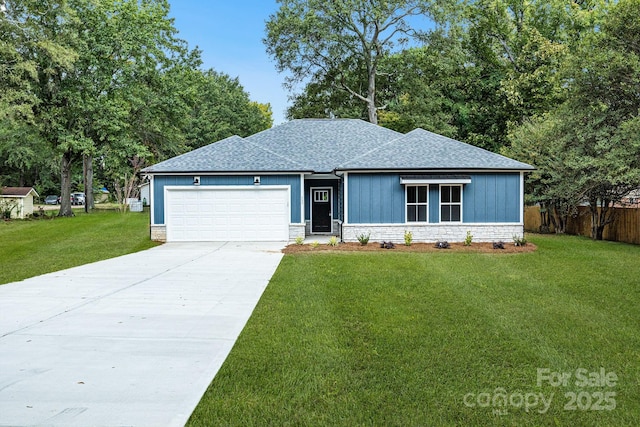 view of front of house with a front lawn, an attached garage, driveway, and roof with shingles