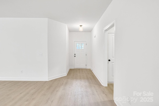 foyer with baseboards and light wood finished floors