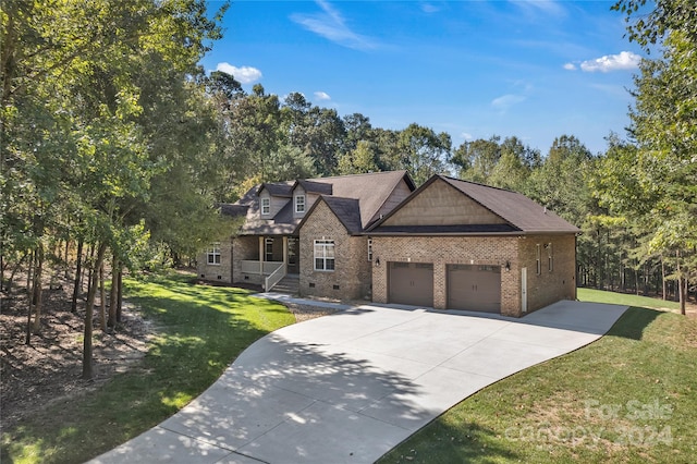 view of front of home with a front lawn and a garage