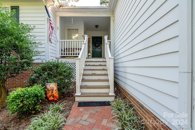 view of exterior entry featuring covered porch