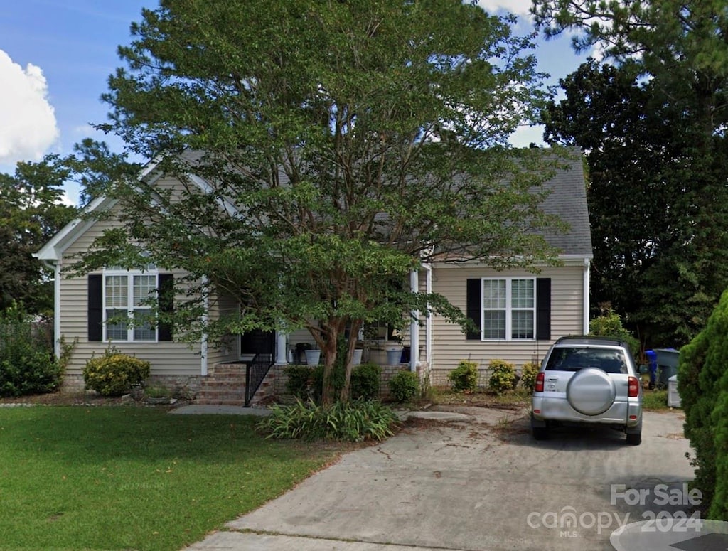 obstructed view of property featuring a front lawn