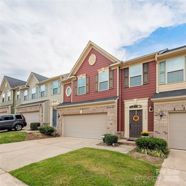 multi unit property with driveway, a garage, and brick siding