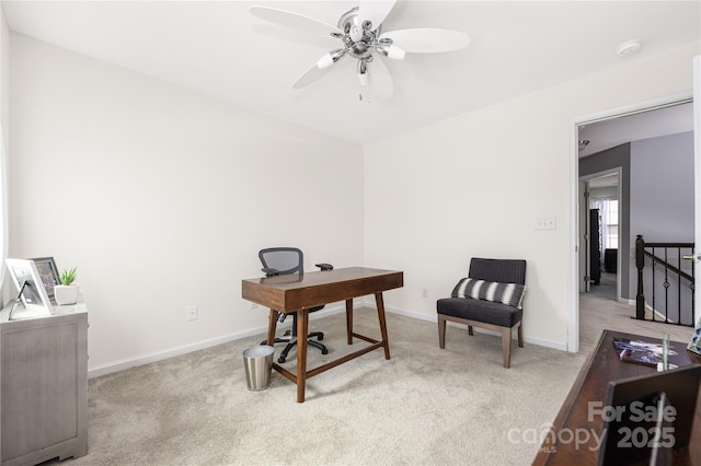 office area featuring a ceiling fan, baseboards, and carpet flooring