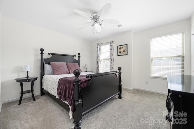 carpeted bedroom with ceiling fan, visible vents, and baseboards