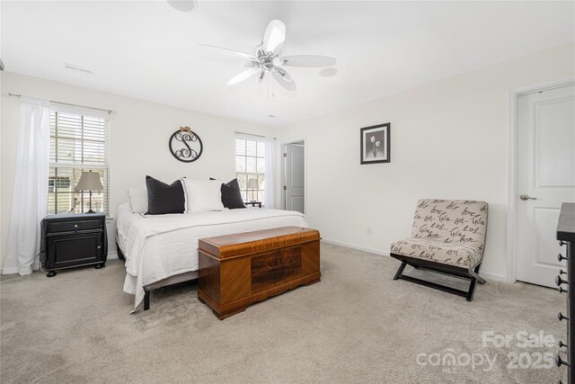 bedroom featuring carpet floors, multiple windows, baseboards, and a ceiling fan