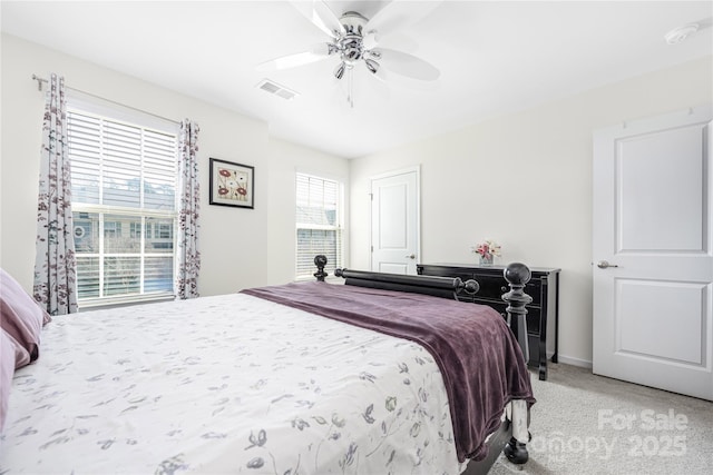 bedroom featuring ceiling fan, carpet floors, visible vents, and baseboards