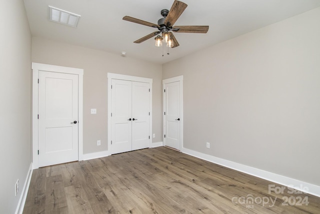 unfurnished bedroom with ceiling fan and light hardwood / wood-style floors