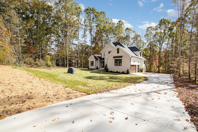 view of home's exterior with a yard and a garage