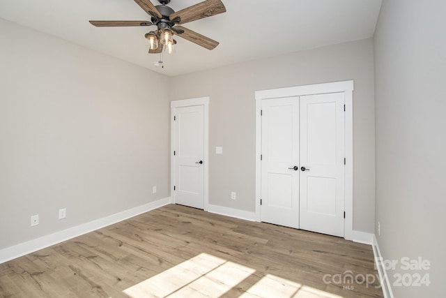 unfurnished bedroom featuring a closet, ceiling fan, and light wood-type flooring