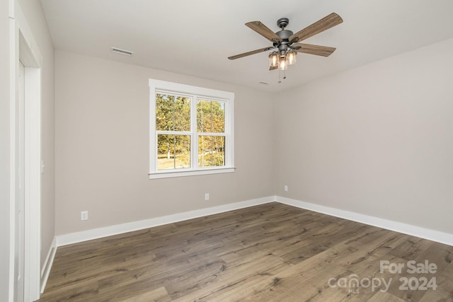 empty room featuring hardwood / wood-style floors and ceiling fan