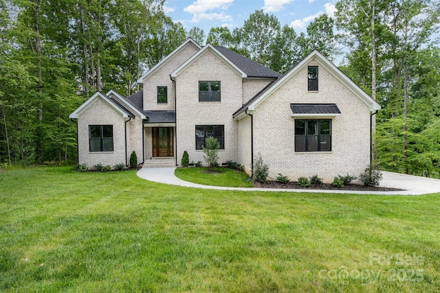 view of front of property with a front yard and brick siding