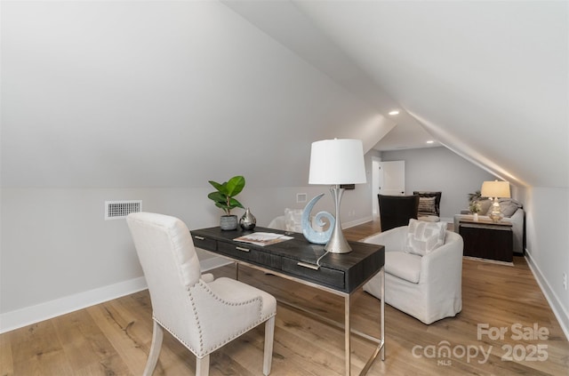 office featuring baseboards, vaulted ceiling, wood finished floors, and recessed lighting