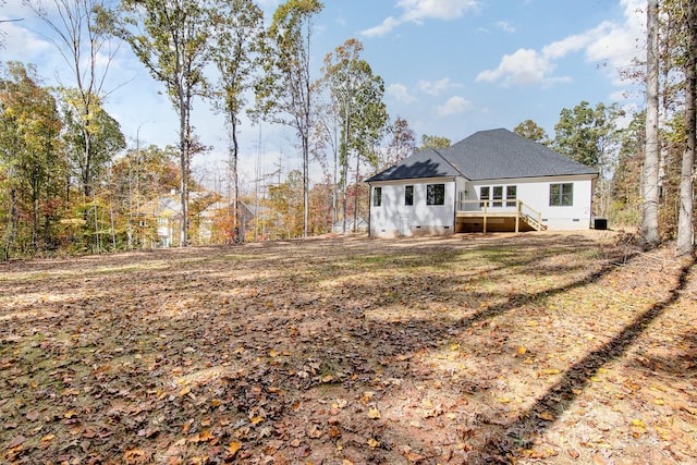 rear view of property with crawl space and a shingled roof