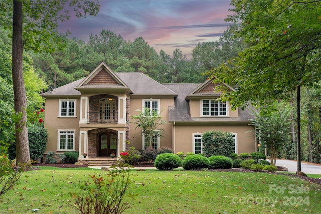 view of front facade featuring a yard and french doors