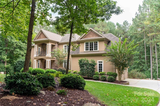 view of front of house featuring a balcony and a garage