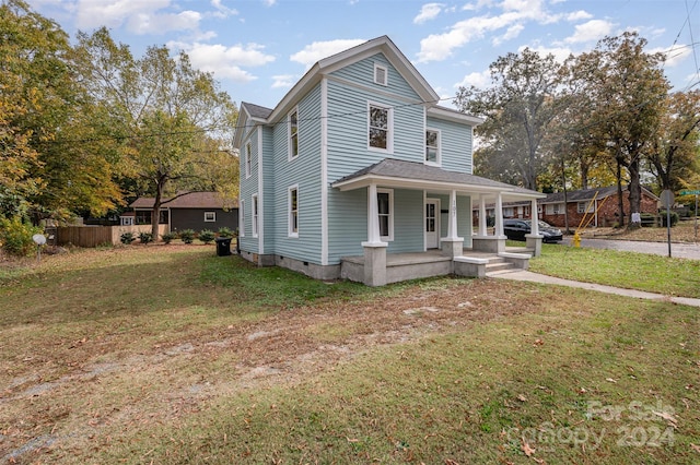 front facade with a porch and a front lawn