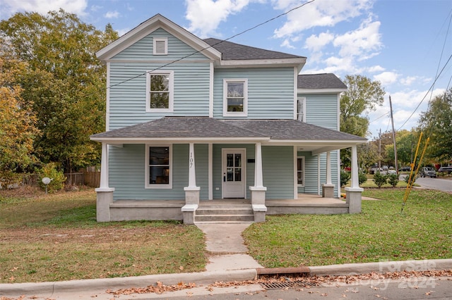 view of front of house with a porch and a front lawn