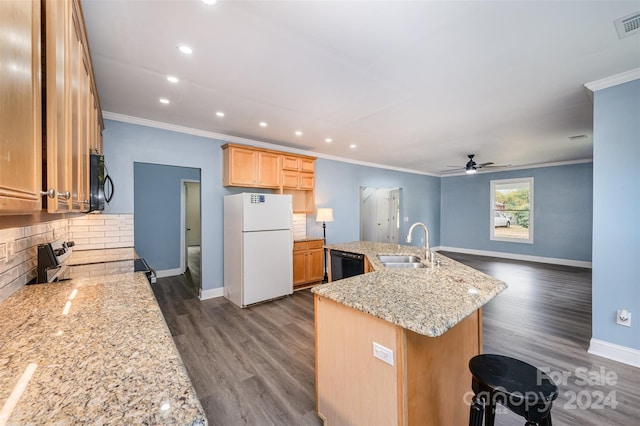 kitchen with dark wood-type flooring, light stone counters, decorative backsplash, black appliances, and sink